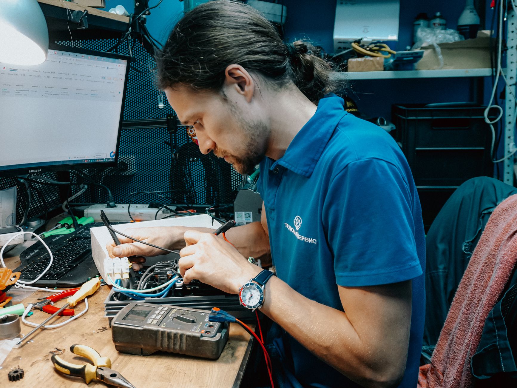 Electrician repairing electrical equipment with tools — call X.Q Electrical in Doncaster